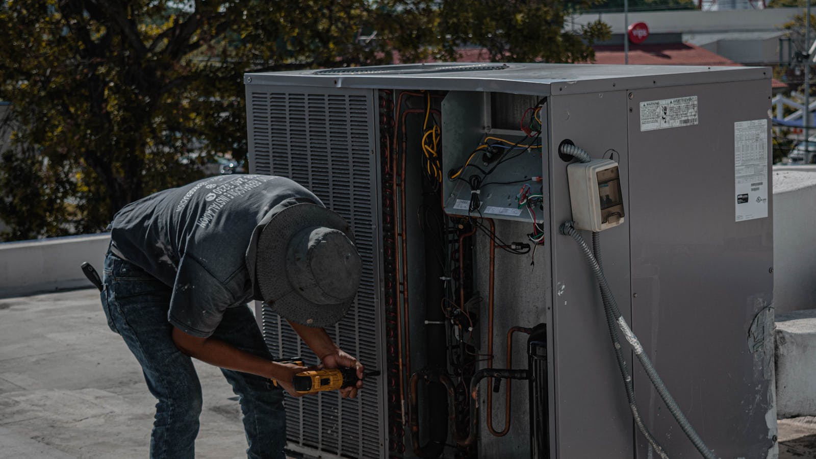 HVAC technician working on a rooftop unit